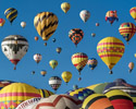 colourful hot air balloons floating in a bright blue sky